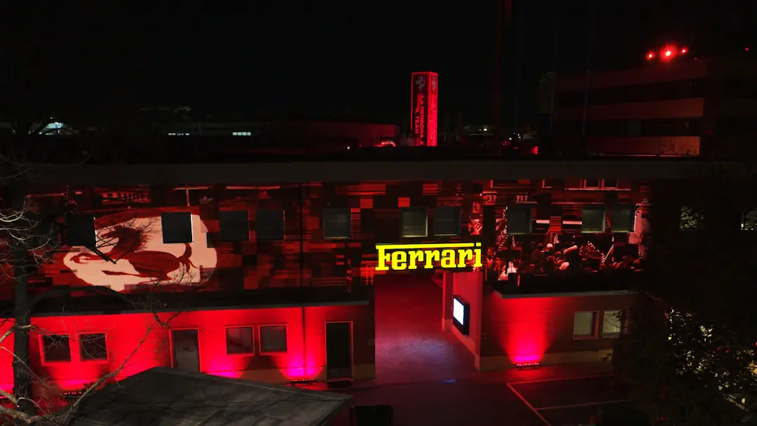 Ferrari Maranello tour – historic factory entrance illuminated at night. © Ferrari Media Centre