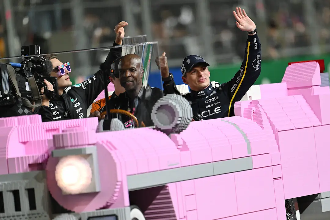 Formula 1 Las Vegas Grand Prix 2025 Race Report: Verstappen Steals the Show in Las Vegas 7 Max Verstappen, Lando Norris and George Russell ride to the podium in a bright pink Lego Cadillac driven by Terry Crews after the Las Vegas Grand Prix, waving to fans under the lights. © Red Bull Content Pool — F1 Las Vegas Grand Prix 2025 Race Review
