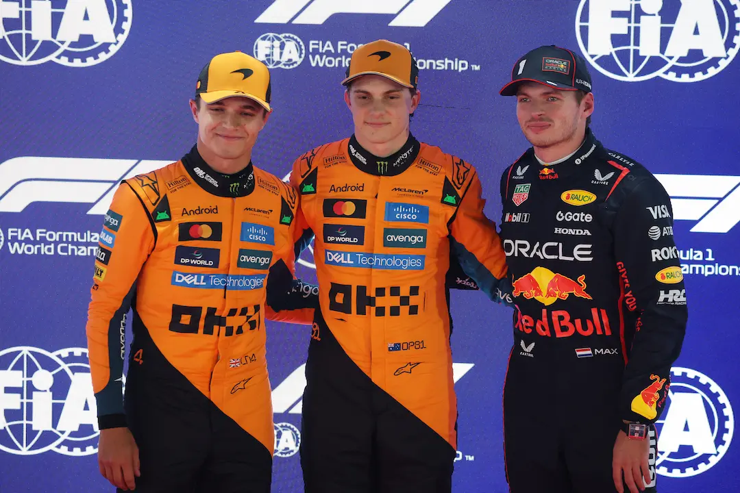 Oscar Piastri, Lando Norris and Max Verstappen stand together after Qatar GP 2025 Qualifying at Lusail, posing for photos as the top three drivers. © Getty Images / Red Bull Content Pool