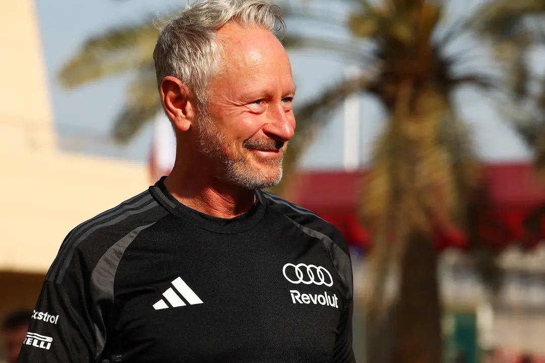 Jonathan Wheatley Aston Martin team principal story image showing Jonathan Wheatley smiling in Audi Revolut F1 Team kit in the Bahrain paddock in 2026 © Audi Revolut F1 Team
