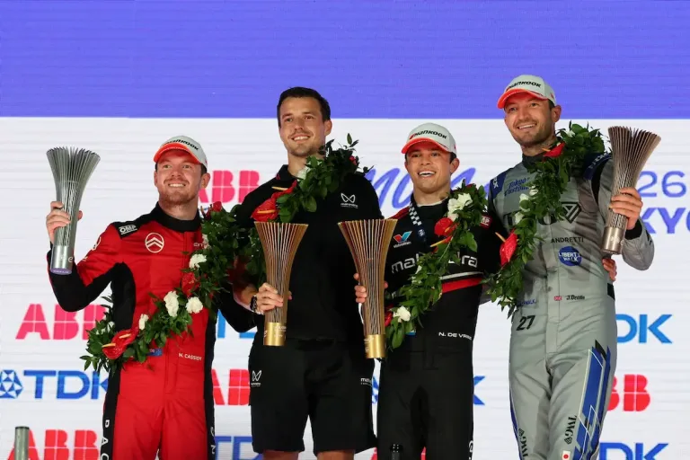 Tokyo E-Prix Round 15 podium with Nick Cassidy, Mahindra Racing representative, race winner Nyck de Vries and Jake Dennis holding trophies © Formula E