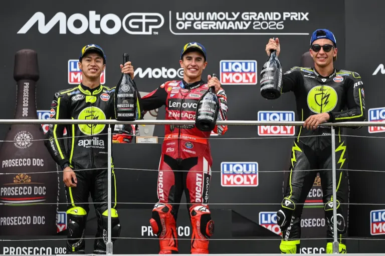 MotoGP German Grand Prix 2026 podium with Marc Marquez in the centre, Ai Ogura on the left and Raul Fernandez on the right celebrating at the Sachsenring © MotoGP
