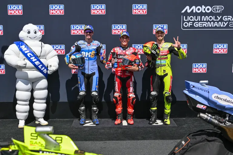 Alex Marquez, Marc Marquez and Fabio Di Giannantonio pose after MotoGP German Grand Prix 2026 Qualifying at the Sachsenring, where they secured an all-Ducati front row. © MotoGP Sports Entertainment Group, 2026