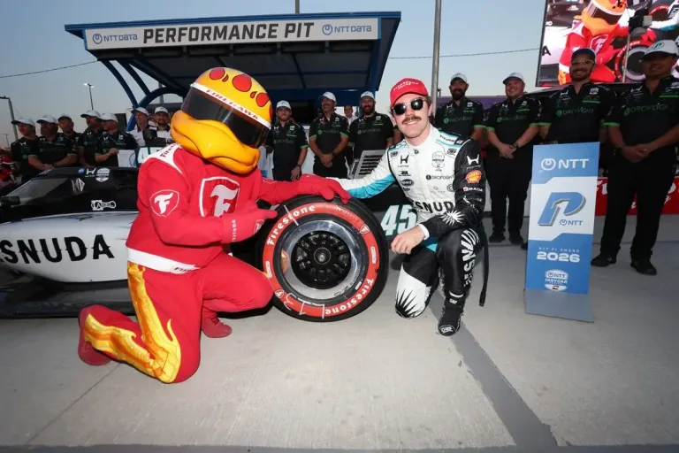 Markham IndyCar Qualifying pole winner Louis Foster with the Firestone Firehawk mascot after setting the track record for Rahal Letterman Lanigan Racing at the 2026 Ontario Honda Dealers Indy at Markham. © Penske Entertainment: Joe Skibinski