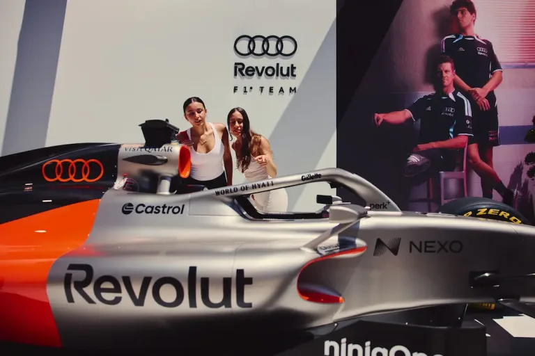 Audi F1 Singapore feature image showing fans with an Audi Revolut F1 Team show car during an off-track activation