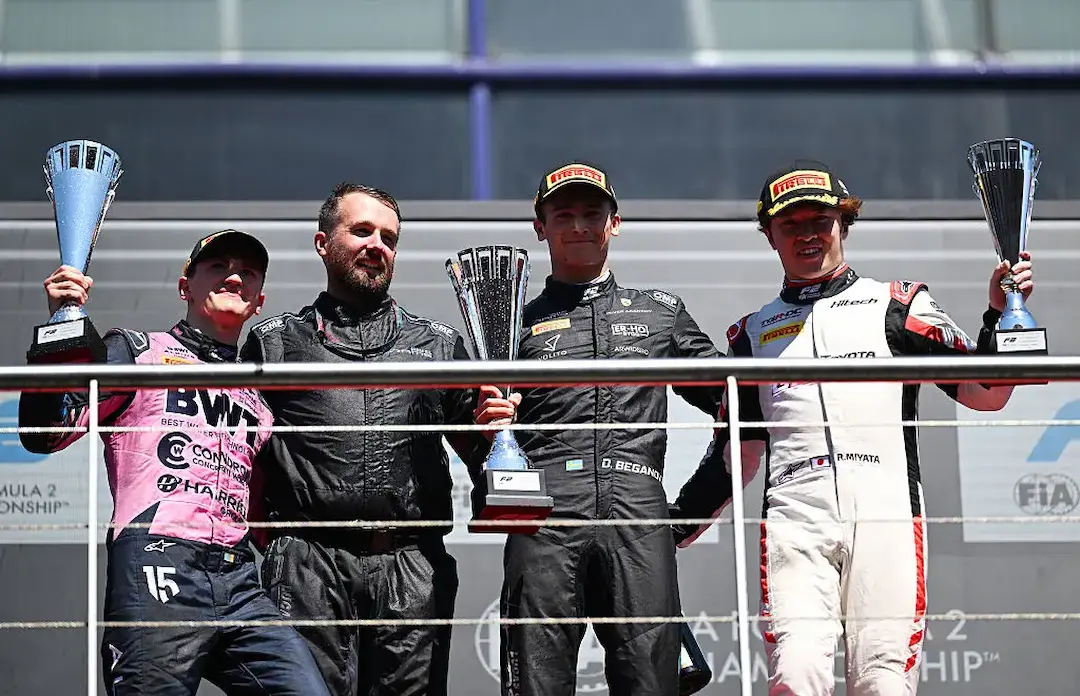 Dino Beganovic celebrates victory in the F2 Madrid Feature Race 2026 alongside Alexander Dunne and Ritomo Miyata on the Madring podium. © Getty Images / Formula 2